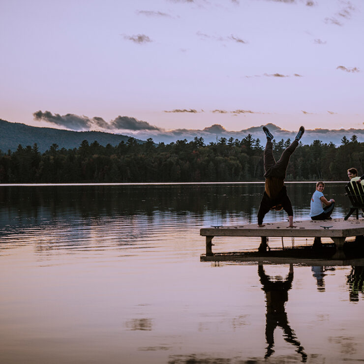 Paul Smith's student doing handstand on the dock